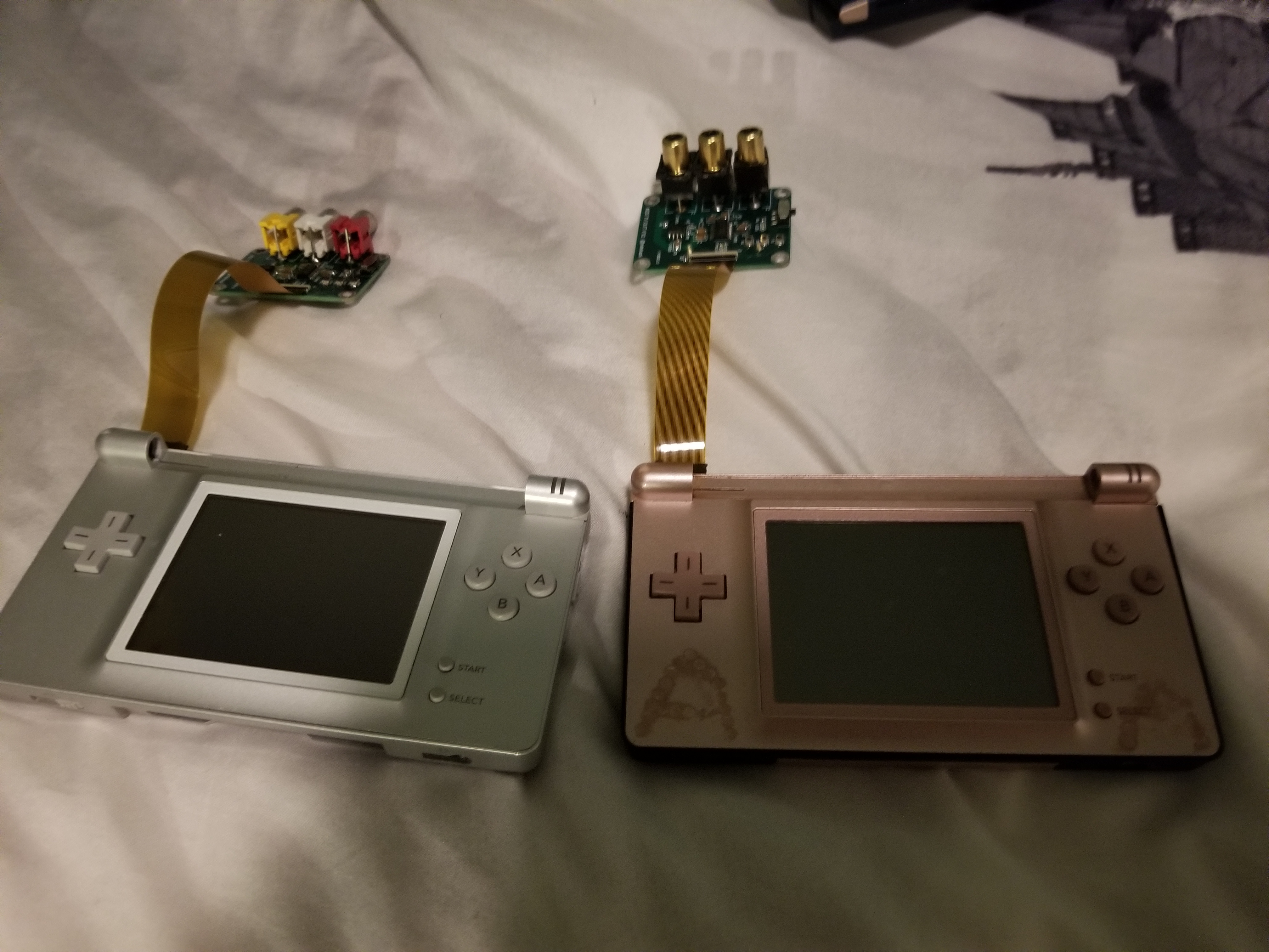 The fully assembled tv out boards attached to their respective DS Lite.